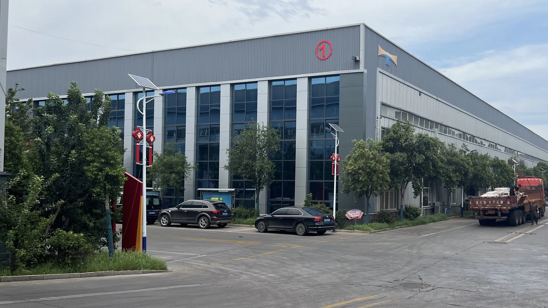 Real industrial factory exterior supporting solar mounting hardware supply
